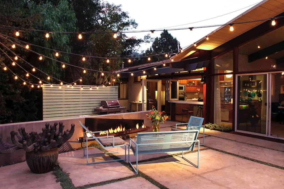 Install string lights for enchanting nighttime vibes in your backyard oasis