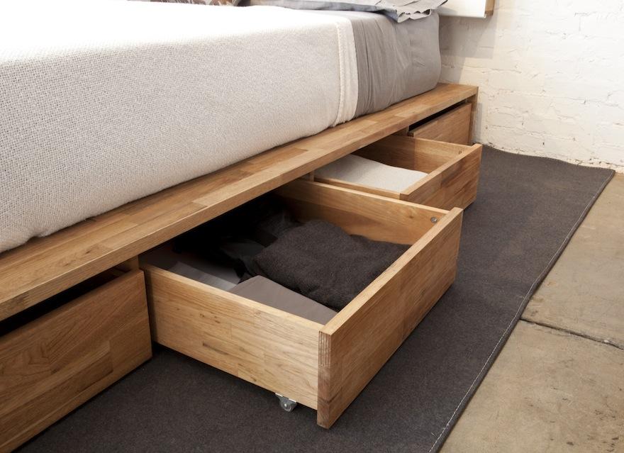 Utilize under-bed storage to maximize space in a minimalist bedroom