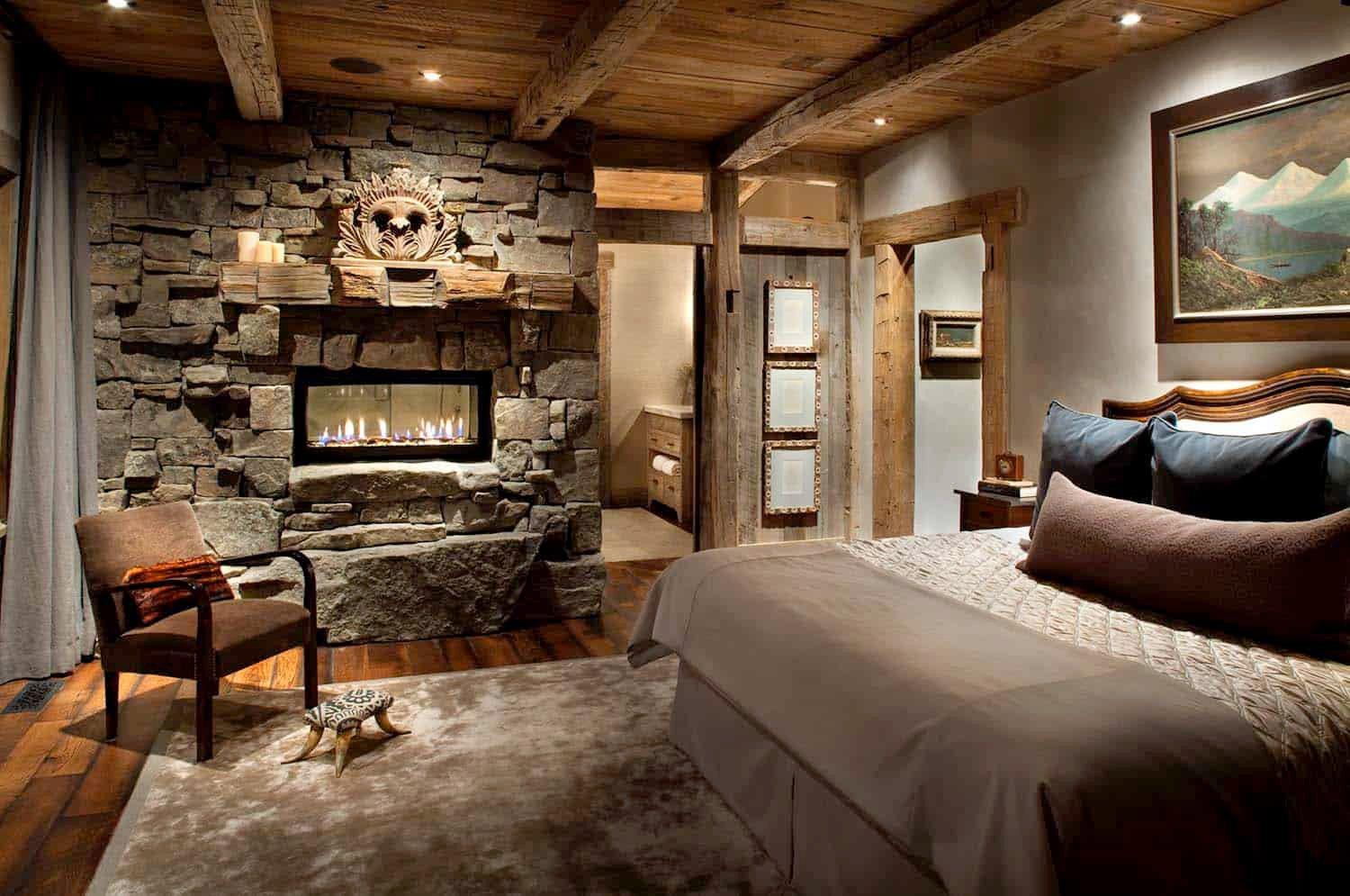 Rustic Lodge Bedroom: A warm fireplace and woodsy elements evoke cabin comfort