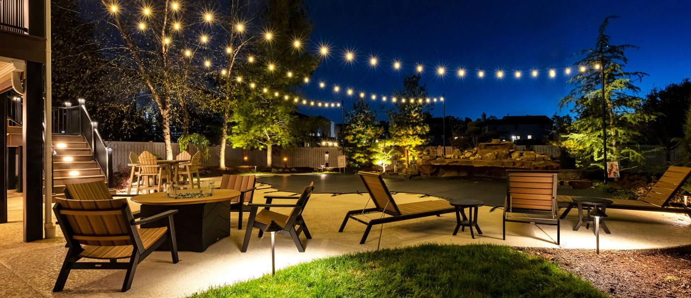 Hang ​string lights to add magic to your backyard evenings