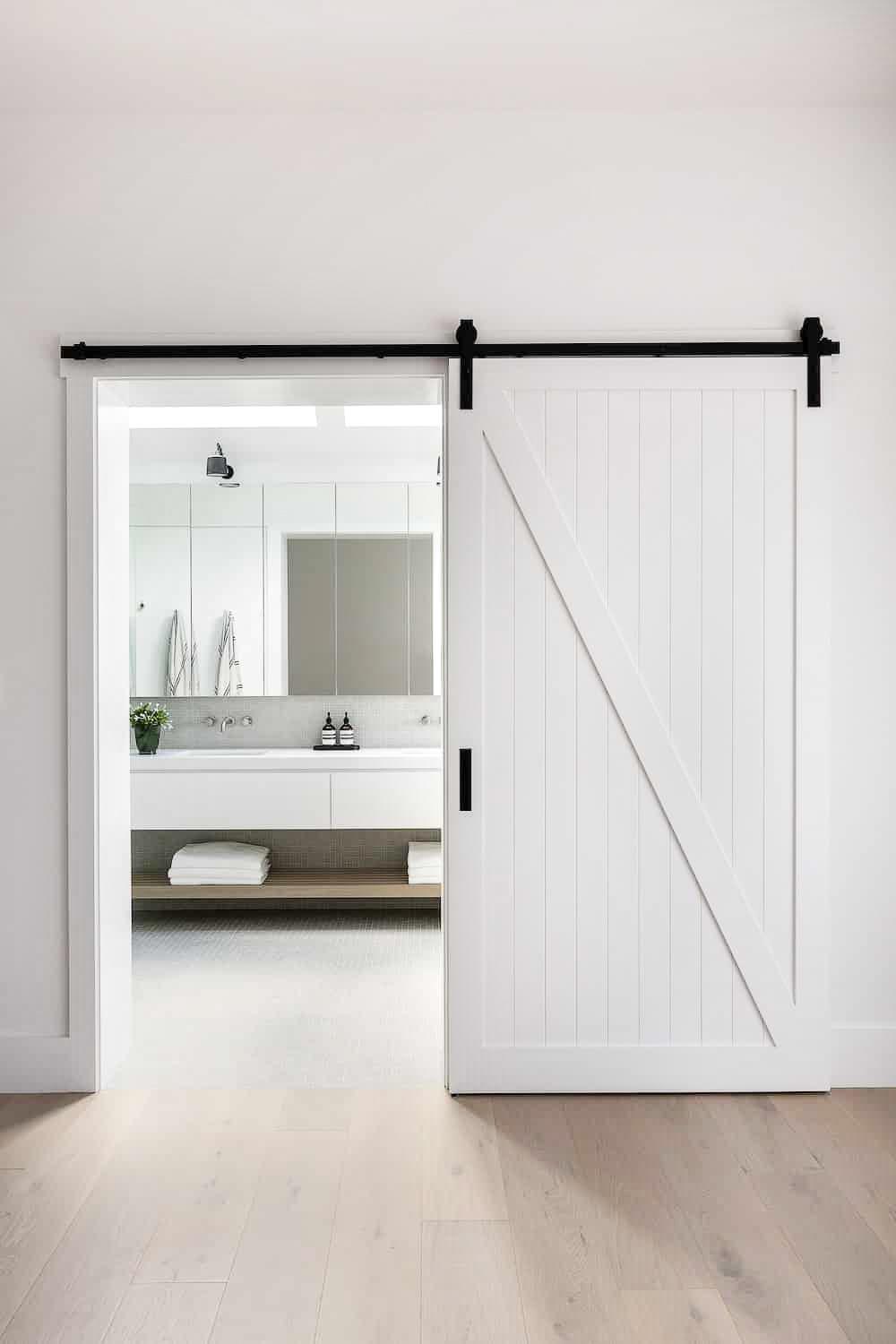 Install a sliding barn door to add a distinct farmhouse touch to your bathroom entry