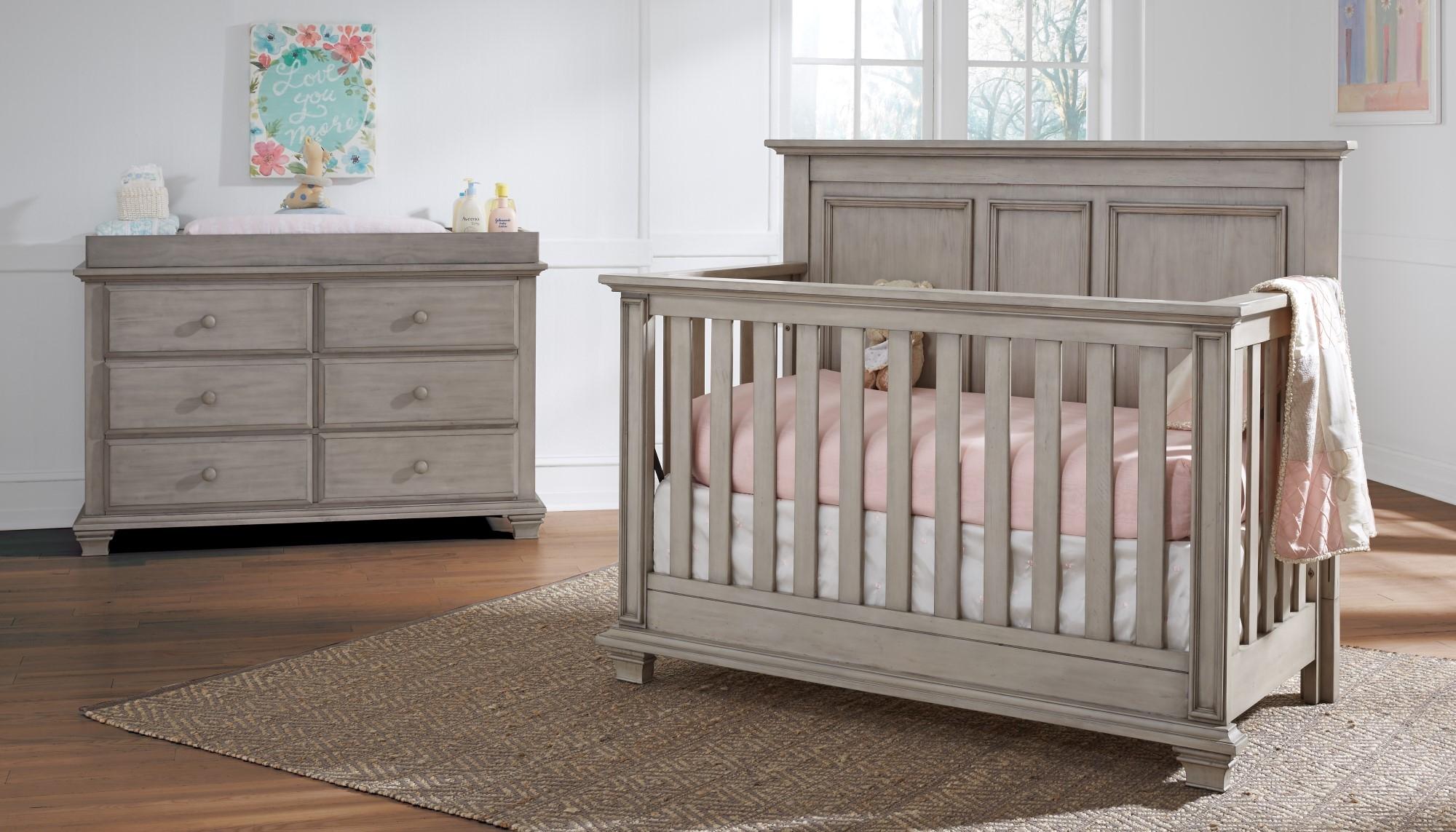 Choose a crib with a built-in dresser for small nursery