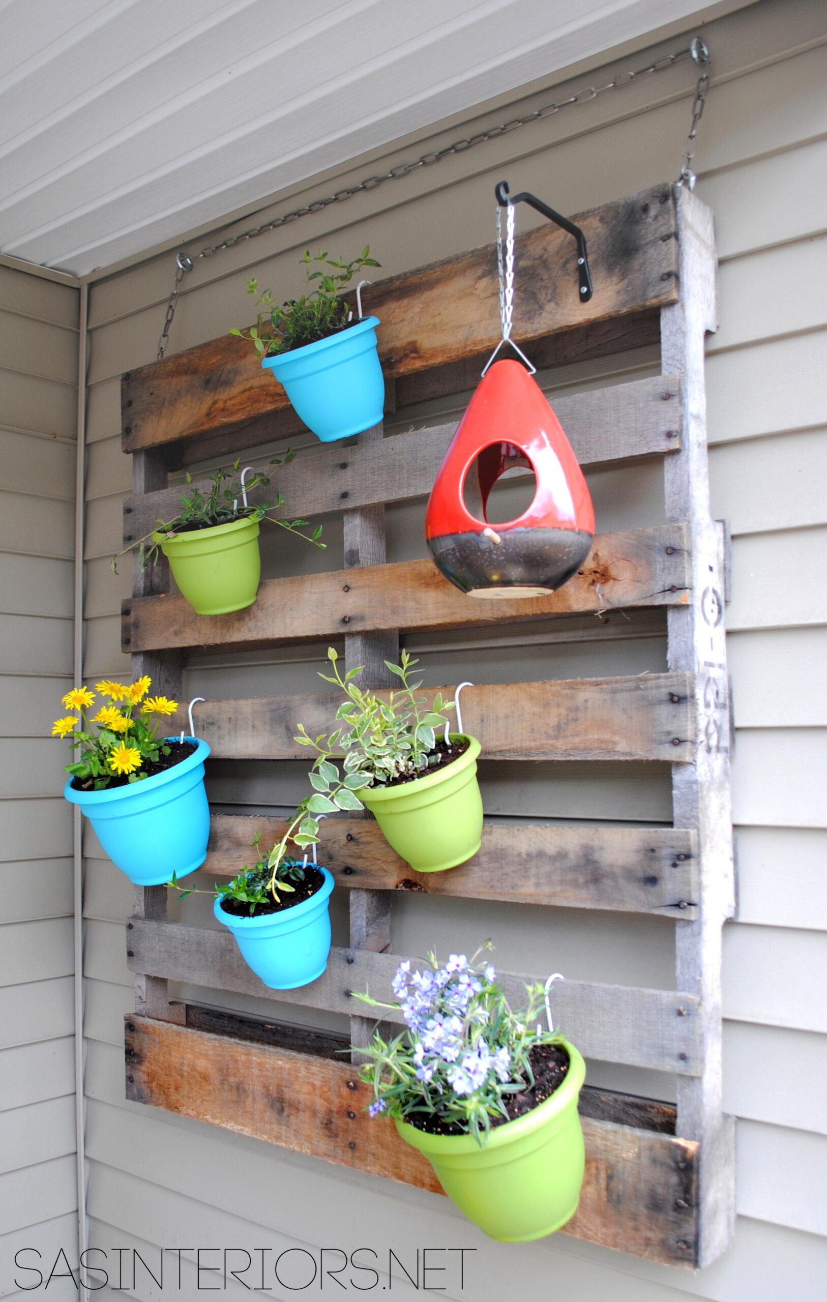 Fashion a playful pallet garden with whimsical hanging planters