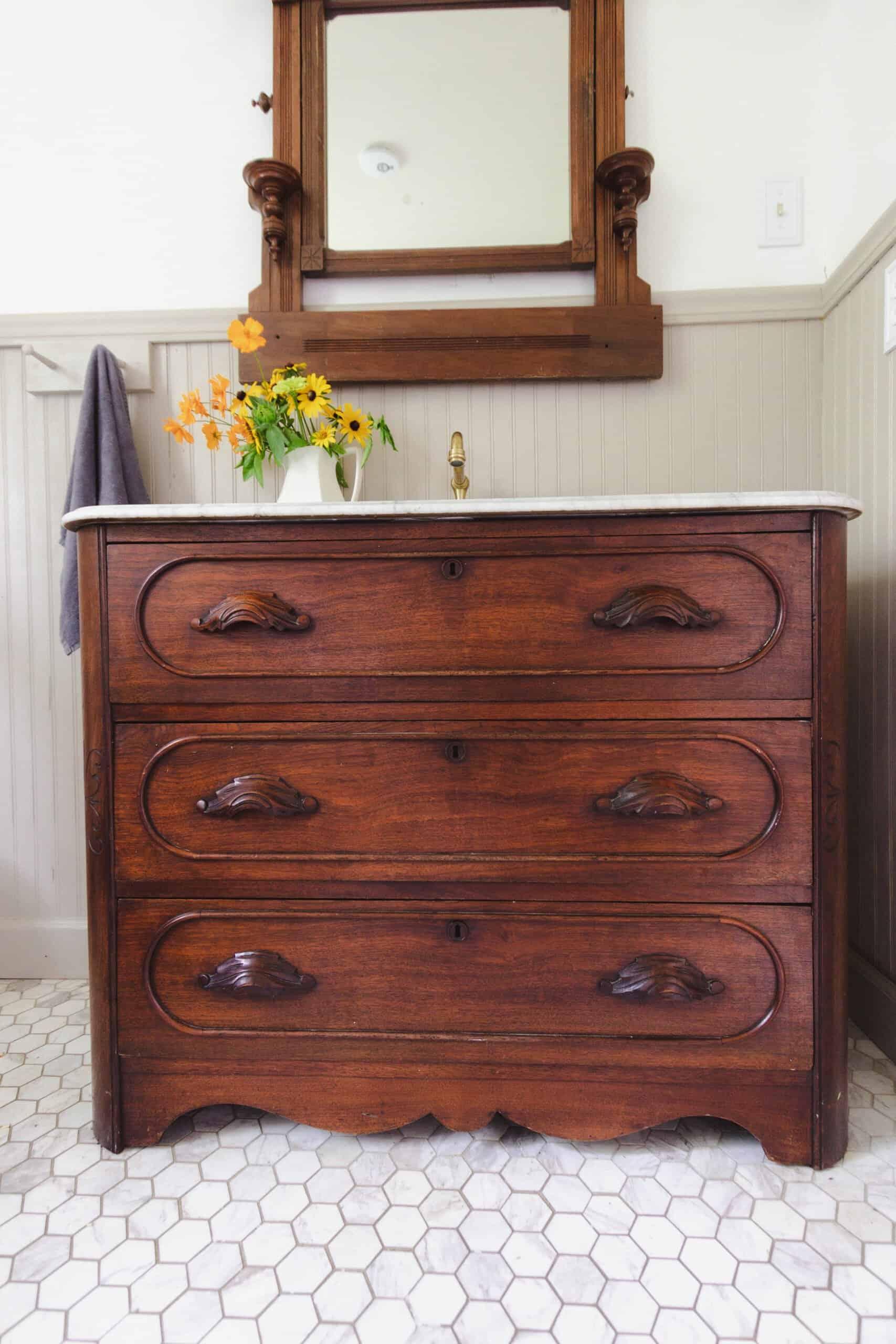 Create a unique vanity ‌by upcycling an antique dresser in your eclectic bathroom