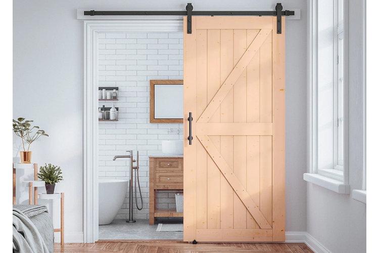 A wooden bathroom barn door ‍adds a unique touch while saving space elegantly