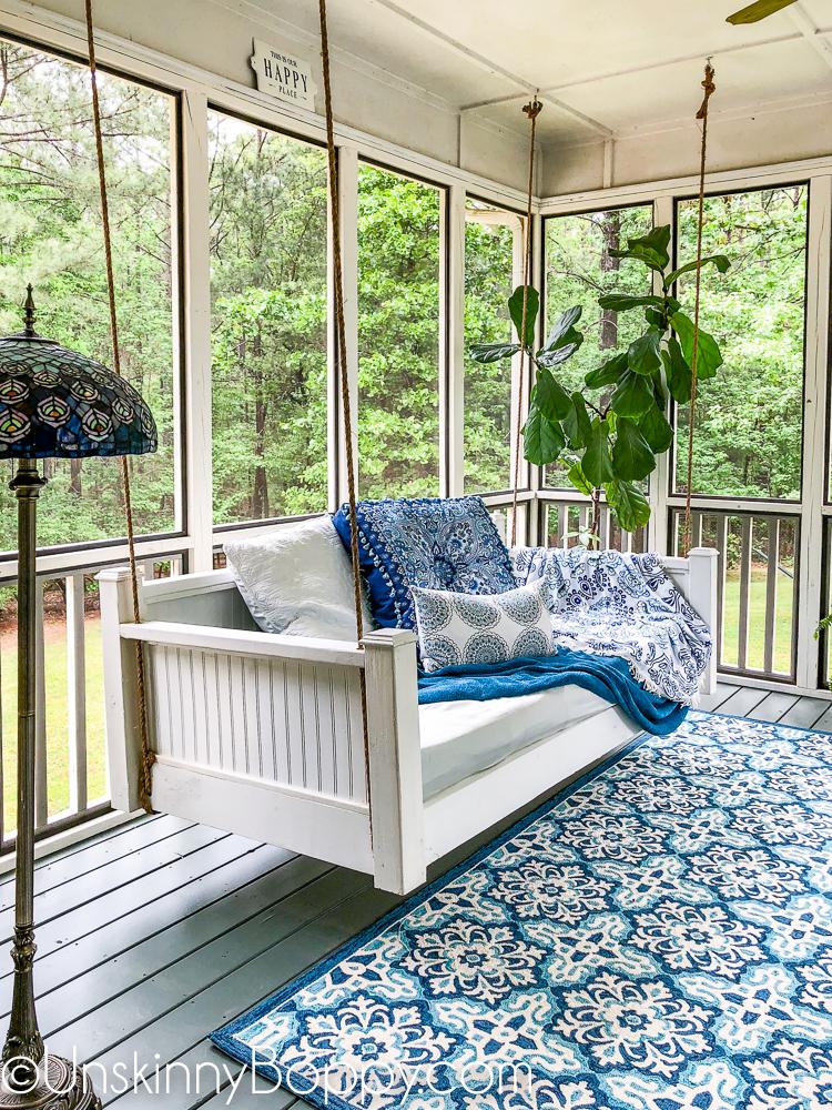 Use repurposed furniture for unique character in your screened porch