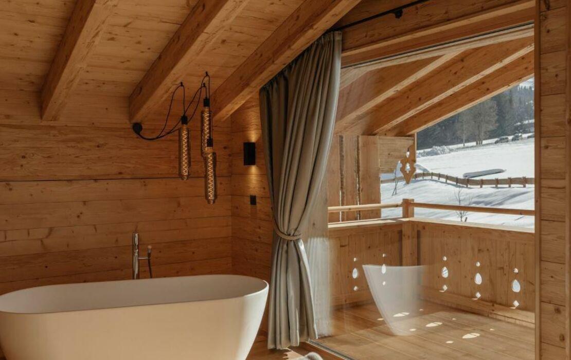 A wooden bath caddy for soaking​ with a book ​in the Chalet ⁤Bathroom