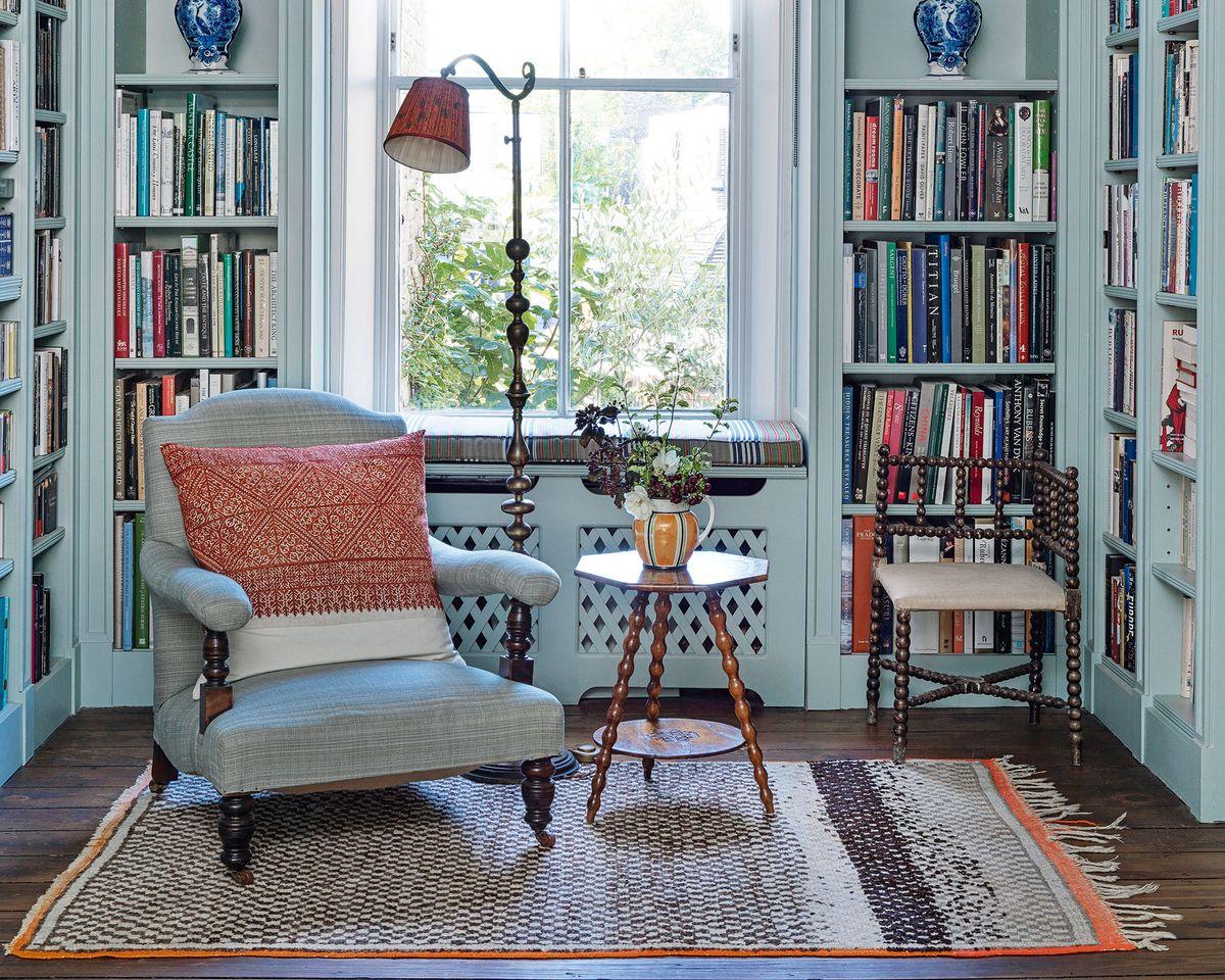 Bookshelves filled with vintage books create a cozy reading corner in your living room