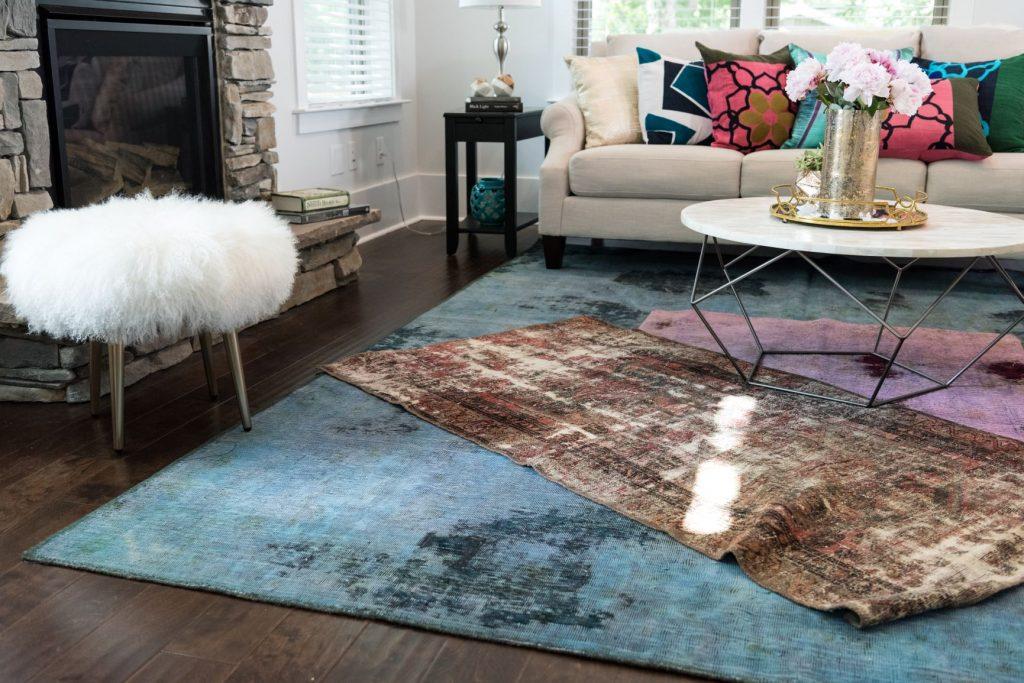 Layered area rugs soften the space and enhance the charm of a vintage living‍ room