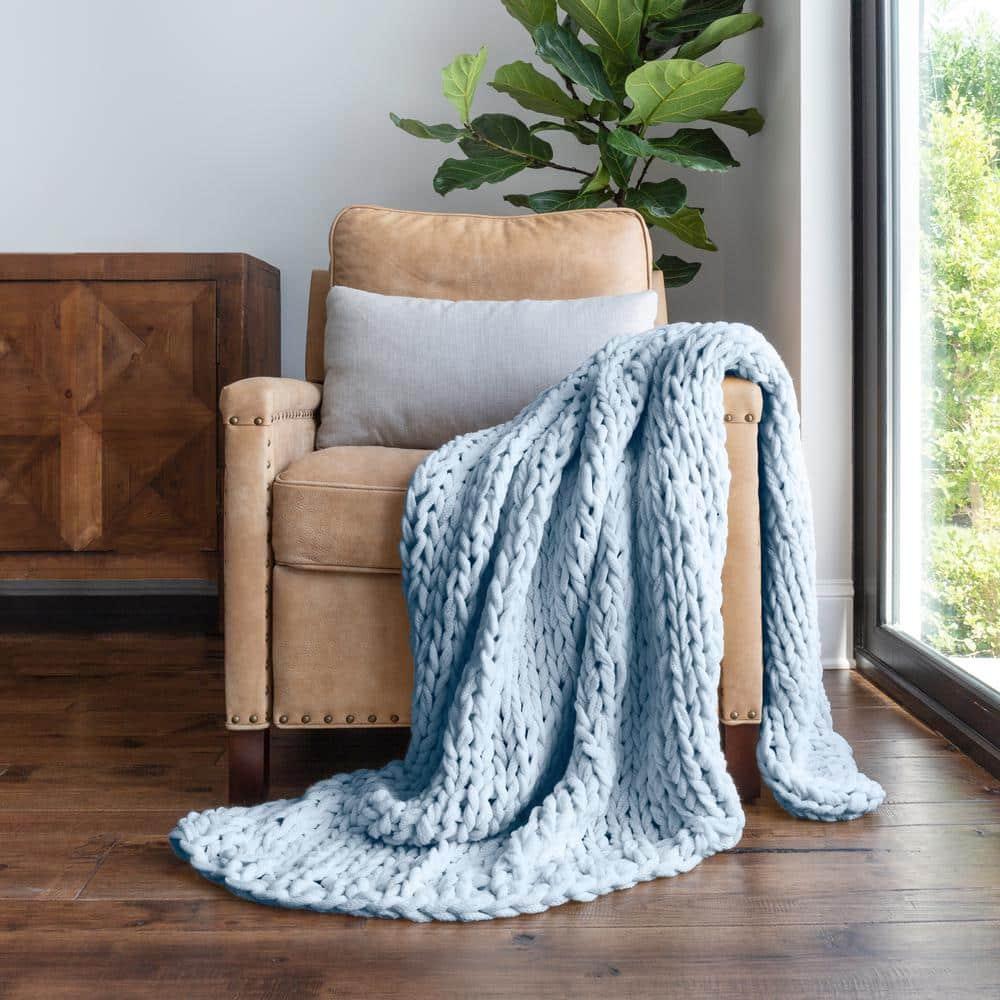 Use blue-themed throw blankets for warmth and texture