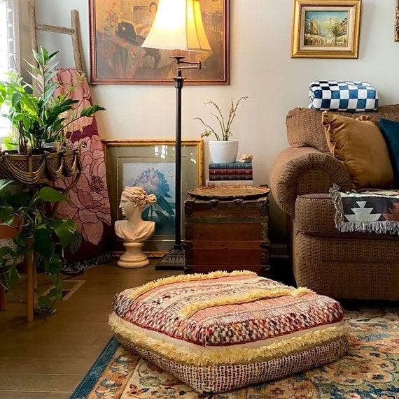 Include a statement piece like a​ colorful pouf in your ​Boho Living Room