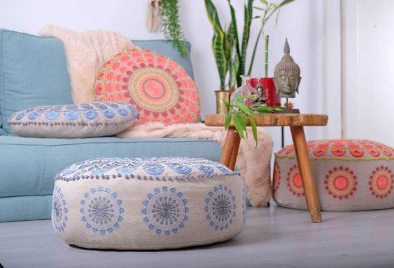 A colorful pouf provides extra seating and a fun accent in​ your Boho Living Room