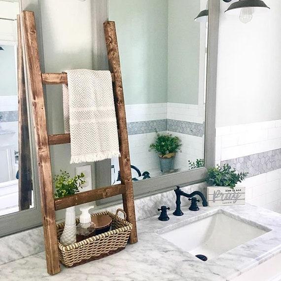 A ⁢vintage ladder serves as ‌a unique towel display in ‍your boho bathroom