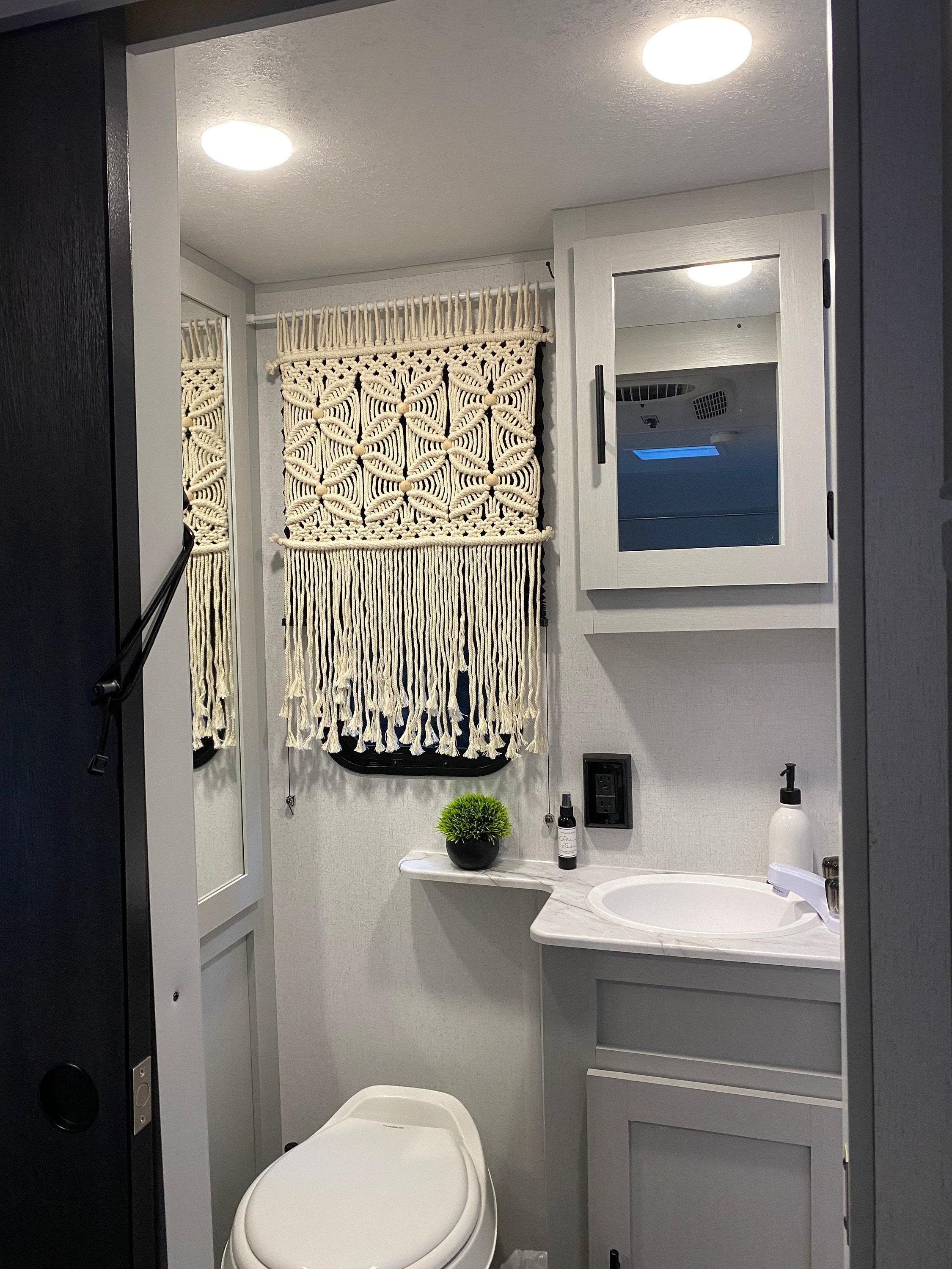 Macramé accents elevate ​your boho bathroom aesthetic beautifully