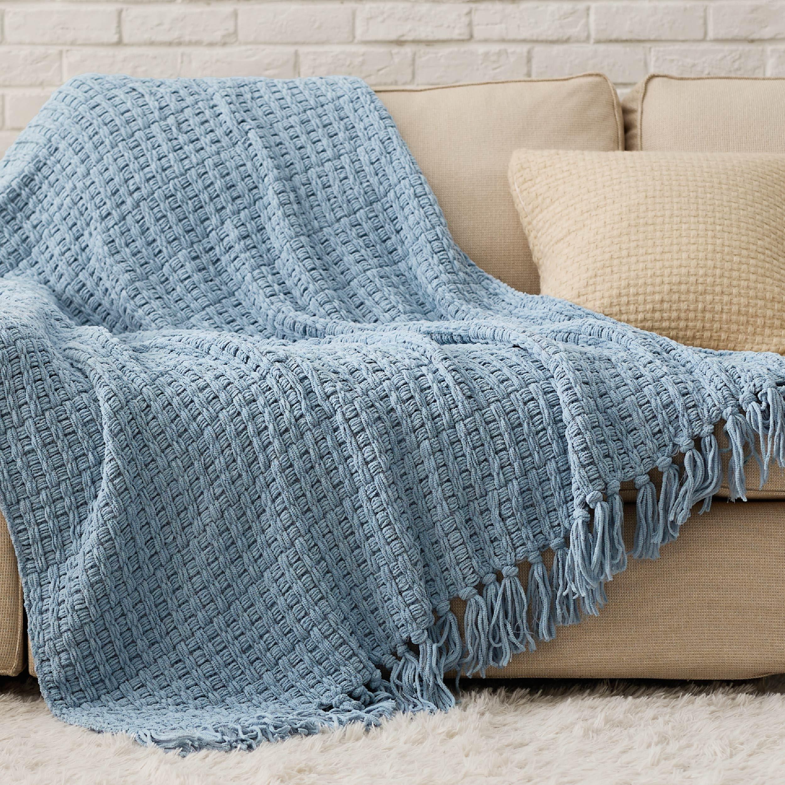 Layer textures with blue cushions and ‍knit throws in your living room