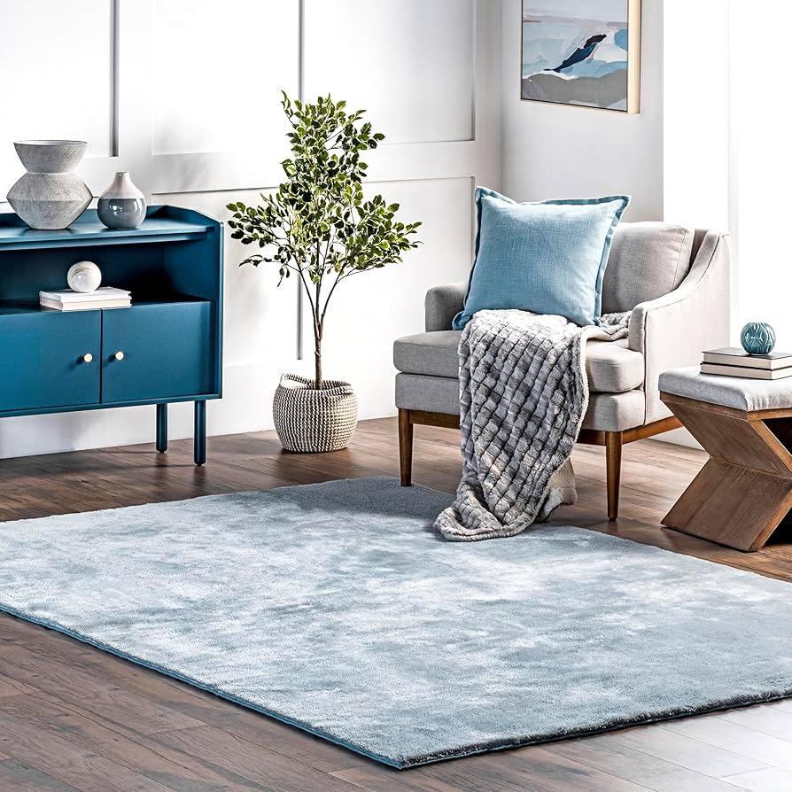 Add a cozy blue area rug for warmth and ​comfort