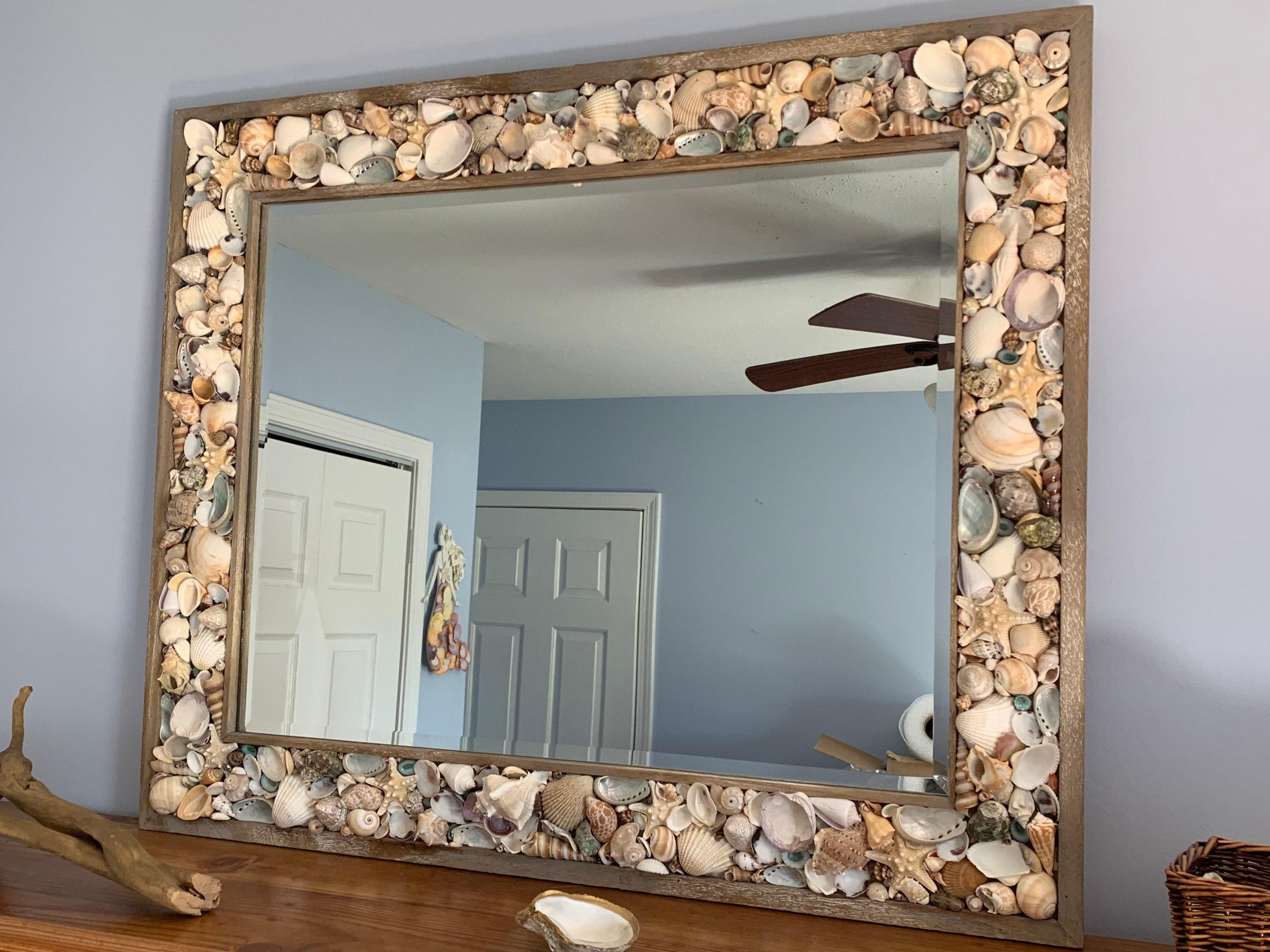 Seashells and driftwood accentuate a beachy boho ⁢bathroom feel