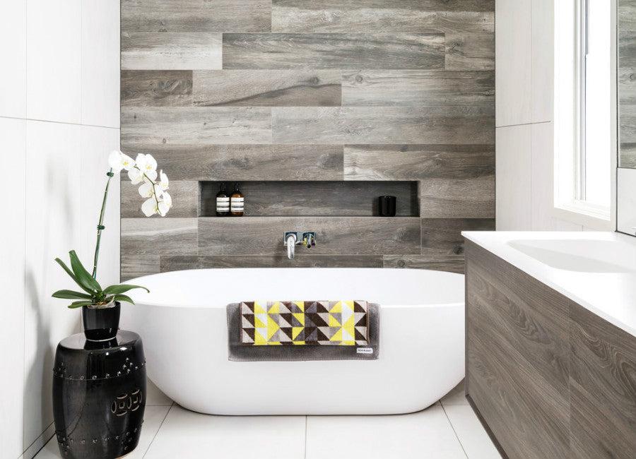 Feature an accent wall with patterned tiles in your Chalet Bathroom